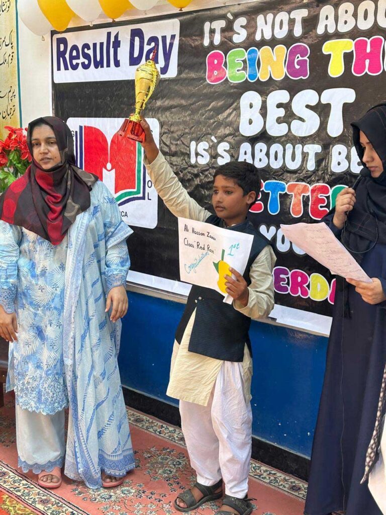 student hold award by taken first position at grammar school foundation